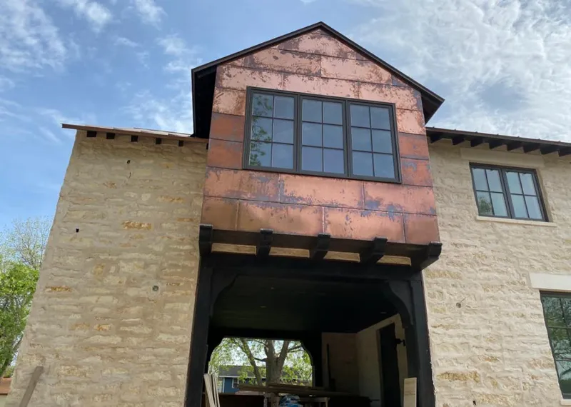 Copper metal panel facade on a stone building for Roof Repair in Burbank